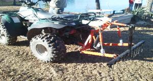 Polaris 4x4 ATV with T-Point Lift three point hitch and Rake